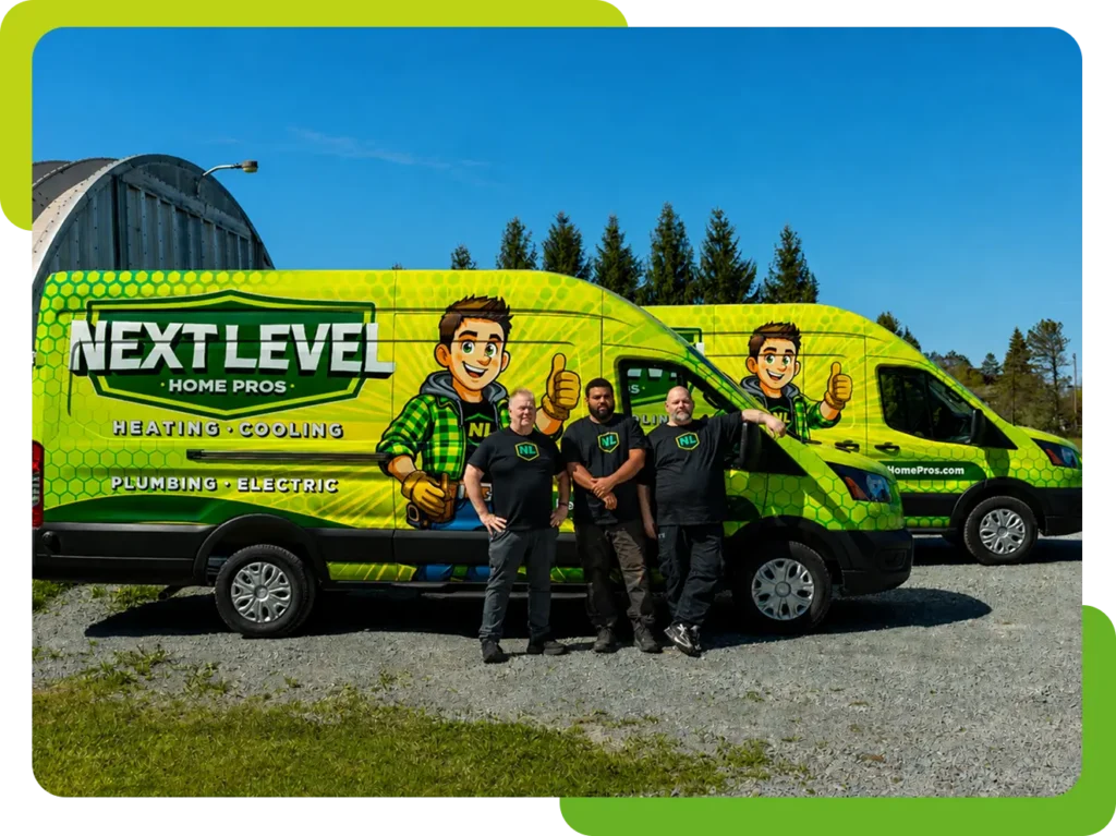 Four people stand in front of two bright green "Next Level Home Pros" vans advertising heating, cooling, plumbing, and electric services, parked on a gravel lot with trees in the background.
