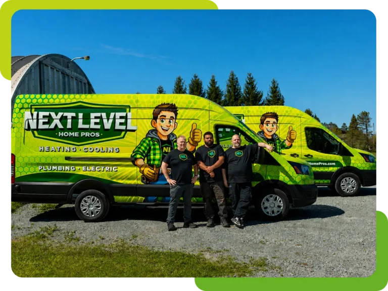 Four people stand in front of two bright green "Next Level Home Pros" vans advertising heating, cooling, plumbing, and electric services, parked on a gravel lot with trees in the background.